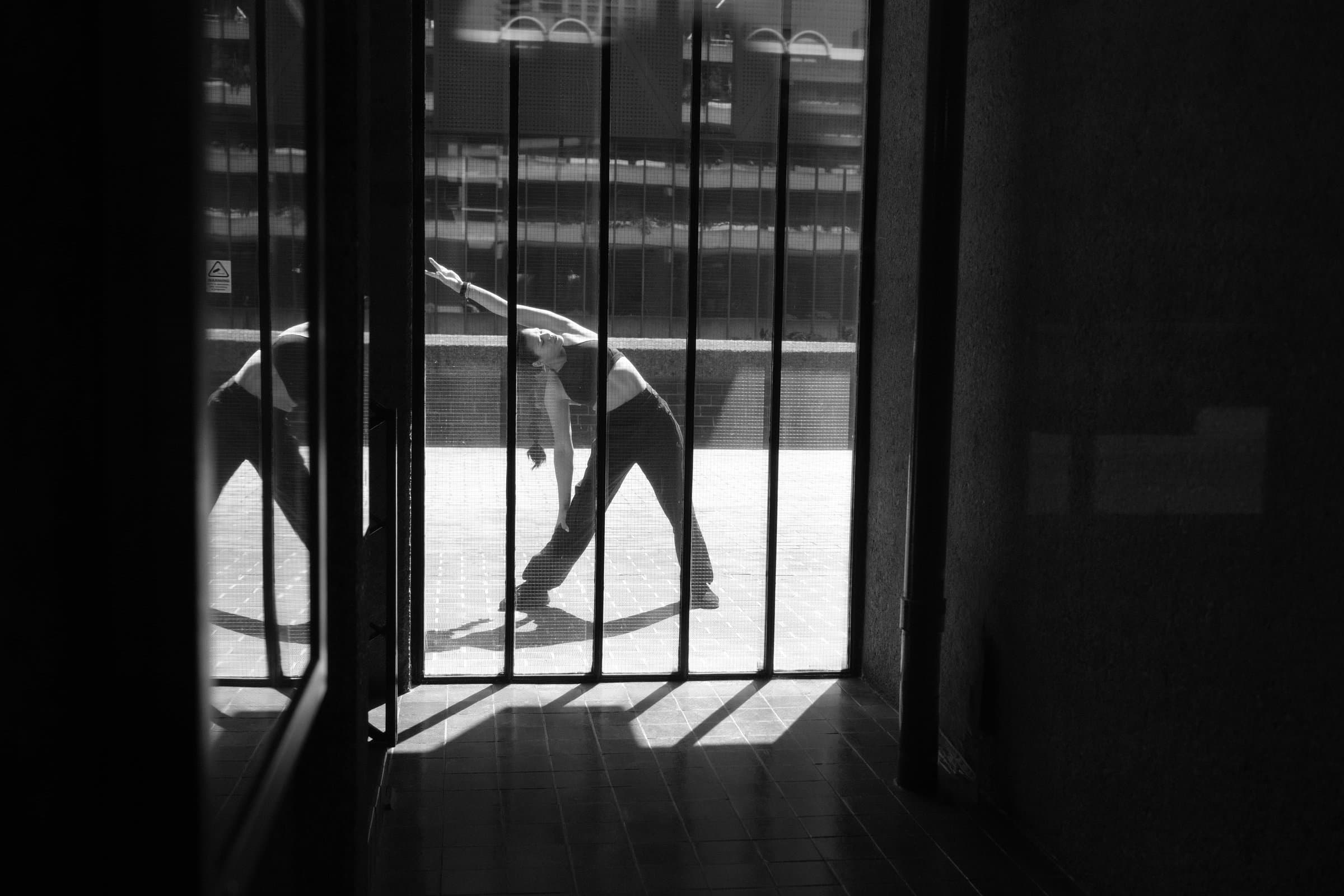 A client stretching in a doorway at the Barbican